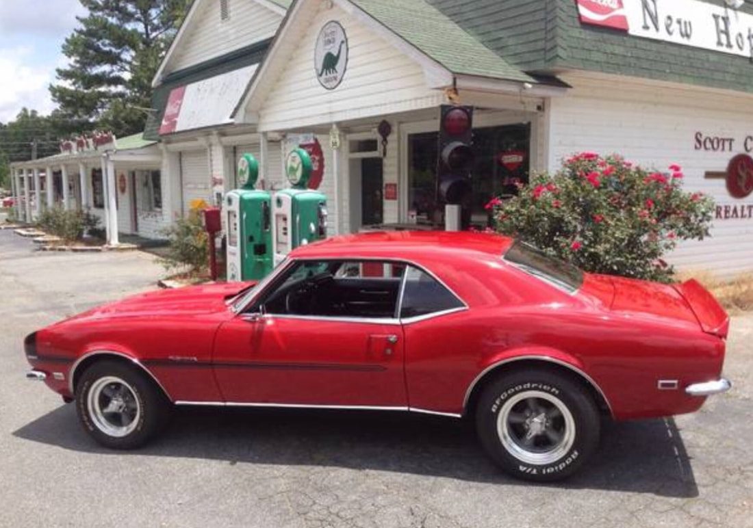 Classic Camaro outside the shop